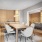 lounge room with a wooden table and connection to a room with seating