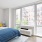 a bedroom with oversized windows
